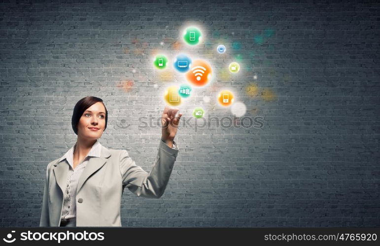 Network connection. Young attractive businesswoman touching media colorful icon