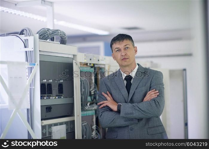 network engineer working in server room, corporate business man