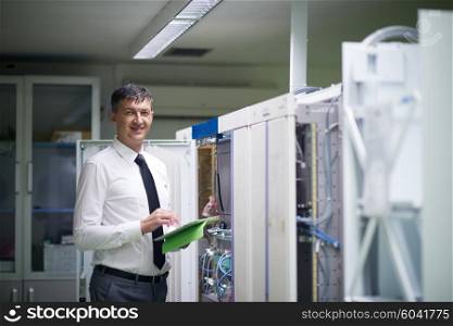 network engineer working in server room, corporate business man working on tablet computer