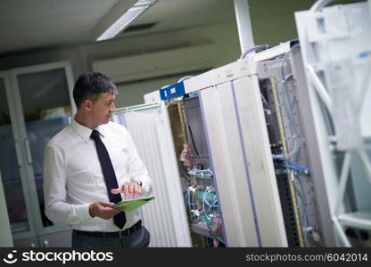 network engineer working in server room, corporate business man working on tablet computer