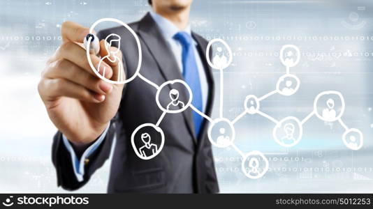 Network marketing. Close up of businessman drawing social net symbols
