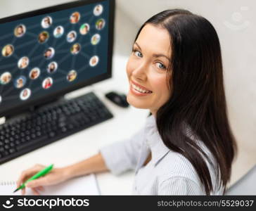 networking, business and technology concept - smiling businesswoman studying with computer