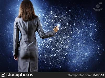 Networking concept. Rear view of businesswoman drawing connection lines