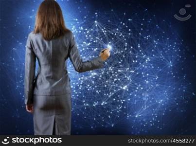 Networking concept. Rear view of businesswoman drawing on media screen