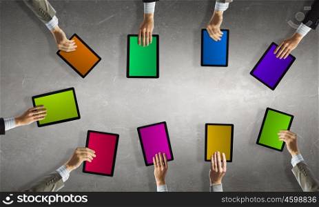 Networking concept. Team of business people holding tablets in hands