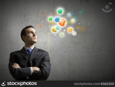 Networking concept. Young confident businessman and colorful media icons