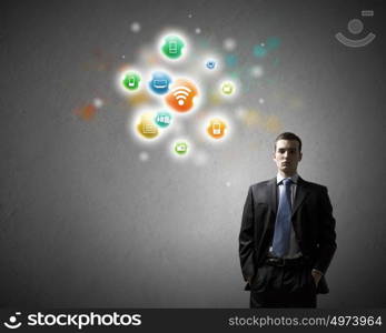 Networking concept. Young confident businessman and colorful media icons