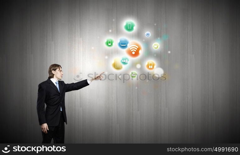 Networking concept. Young confident businessman and colorful media icons