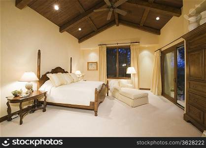 Neutral bedroom with high wooden ceiling