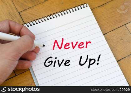 Never give up text concept write on notebook