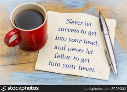 Never let success to get into yout head, never let failure to get into your heart - handwriting on a napkin with a cup of coffee