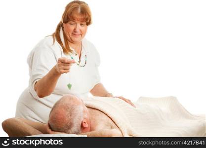 New age healer using a jade pendulum to unblock her patient&rsquo;s energy centers.