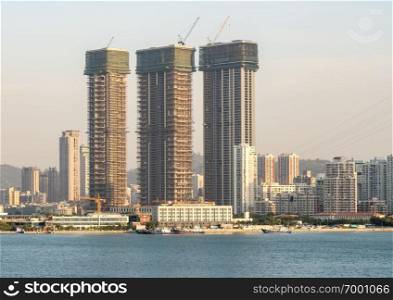 New apartment buildings under construction on seafront of Xiamen. New construction in the city of Xiamen from the sea