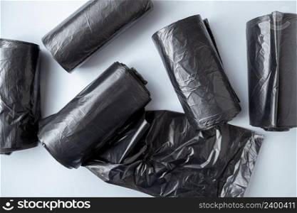 New black garbage bags on a white background.