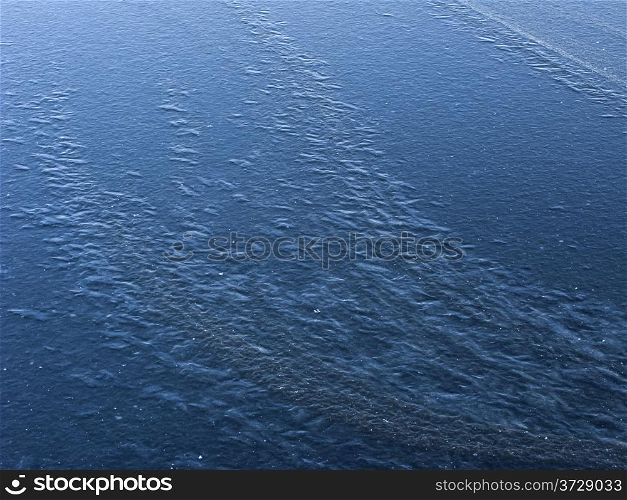 New blue ice surface background on frozen pond