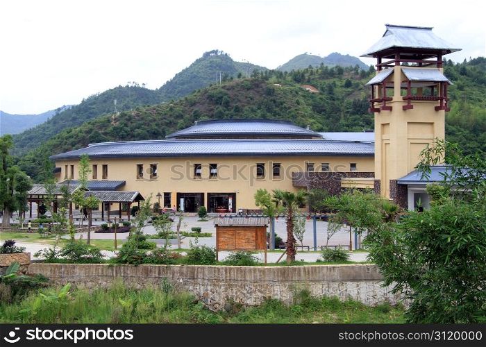 New building near entrance of chinese village with tulou
