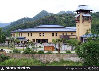 New building near entrance of chinese village with tulou