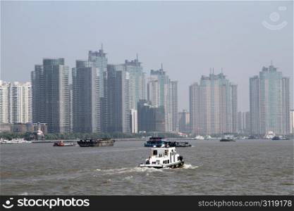 New buildings and boats on the river Huangpu in Shanghai, China