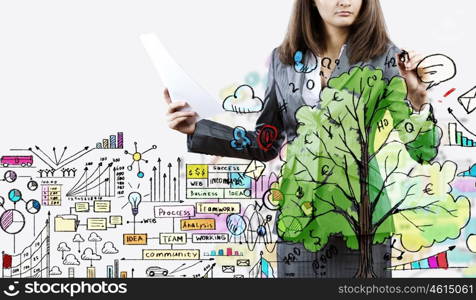 New business plan. Businesswoman drawing business plan and sketches with marker