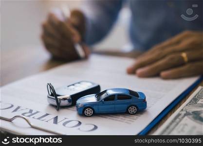 New car buyers are signing car purchase contracts.