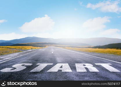 New day new life. Start word as motivation writen on asphalt road