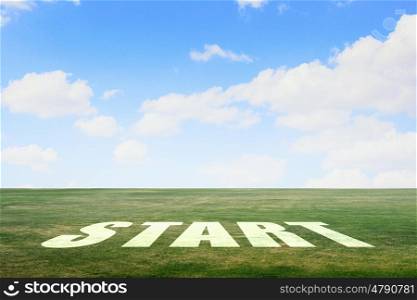 New day new life. Start word as motivation writen on green grass