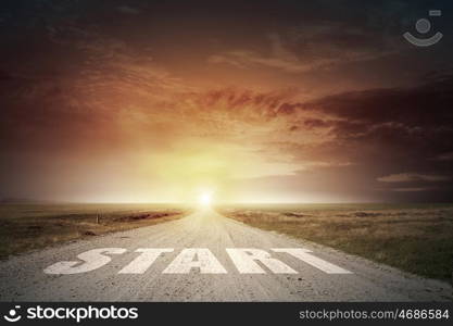 New day new life. Start word on asphalt road and sunrise at horison line