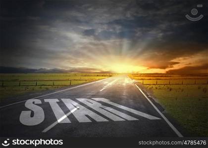 New day new life. Start word on asphalt road and sunrise at horison line
