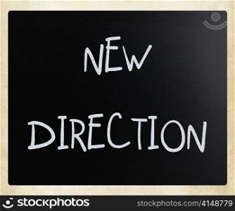 ""New direction" handwritten with white chalk on a blackboard"