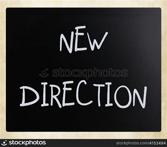 ""New direction" handwritten with white chalk on a blackboard"