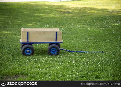 new garden cart with wheels and handles on the green grass
