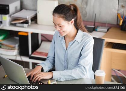 New generation asian business woman using laptop at office, Asian women sitting smiling while working on mobile office concept