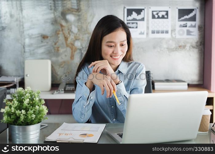 New generation asian business woman using laptop at office, Asian women sitting smiling while working on mobile office concept