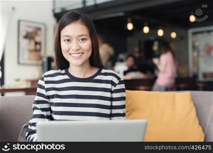 New generation business woman is working with a notebook,Asian female are smiling working in the coffee shop