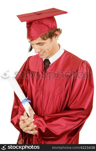 New graduate looks with pride at his diploma. Isolated on white.
