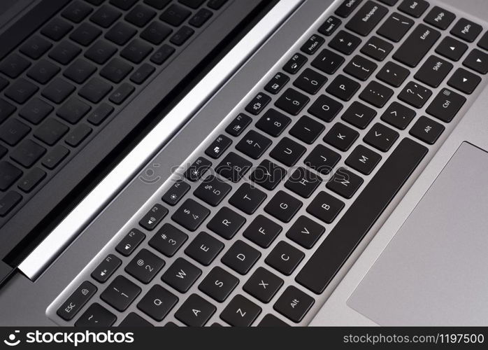 New gray laptop keyboard and screen close up.. New laptop keyboard and screen close up.