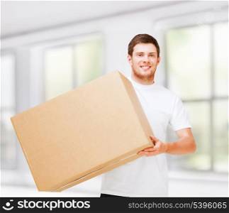 new home and post delivery concept - smiling man carrying carton box