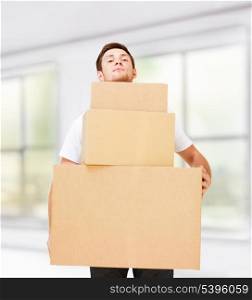 new home and post delivery concept - young man carrying carton boxes