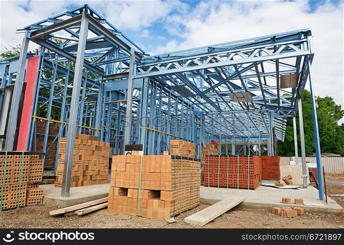 New home under construction using steel frames against a blue sky