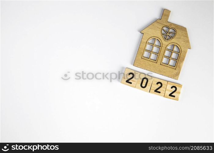 New house model with 2022 wooden blocks number isolated on white background. New year property investment concept. real estate, Mortgage, Financial concept copy space space for text. New house model with 2022 wooden blocks number isolated on white background. New year property investment concept. real estate, Mortgage, Financial concept copy space