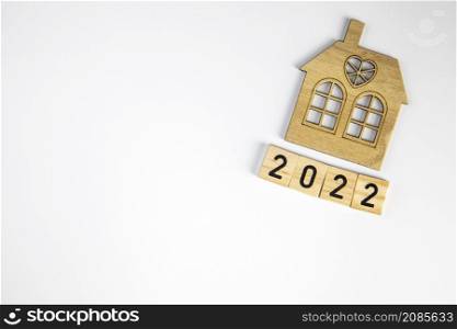 New house model with 2022 wooden blocks number isolated on white background. New year property investment concept. real estate, Mortgage, Financial concept copy space space for text. New house model with 2022 wooden blocks number isolated on white background. New year property investment concept. real estate, Mortgage, Financial concept copy space