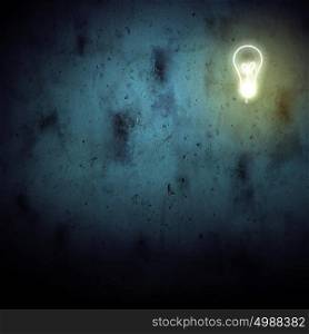New idea. Background image with electric bulb against dark background