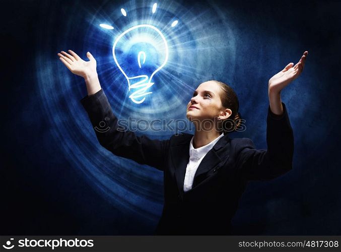 New idea. Young businesswoman praying on light bulb. Problem solution