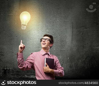 New idea. Young man in casual with book in hand