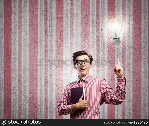 New idea. Young man in casual with book in hand