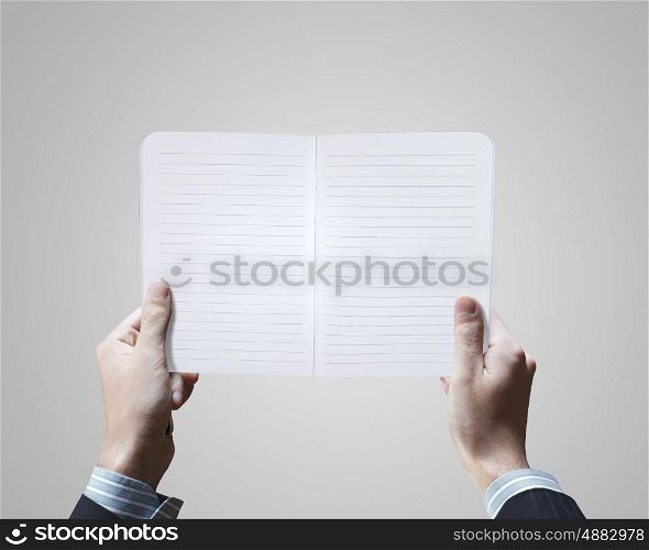 New ideas. Close up of male hands holding opened notepad