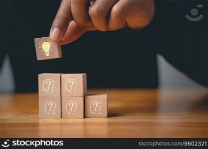 New initiative and strategy consultation. Wooden block with glowing light bulb on hand icon against. Innovative ideas and creative solutions for business success. Expertise and vision for digital