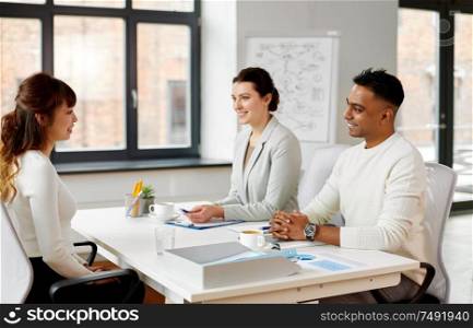 new job, hiring and employment concept - international team of recruiters having interview with asian female employee at office. recruiters having job interview with employee