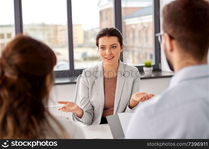 new job, hiring and employment concept - team of recruiters having interview with female employee at office. recruiters having job interview with employee