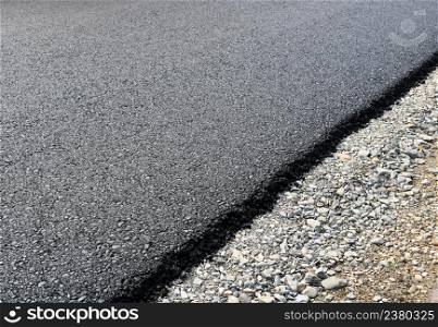 New layer of asphalt road under construction